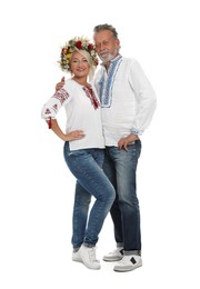 Happy mature couple in Ukrainian national clothes on white background