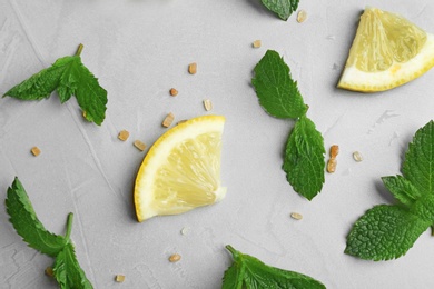 Fresh mint with sliced lemon and sugar on grey background, flat lay