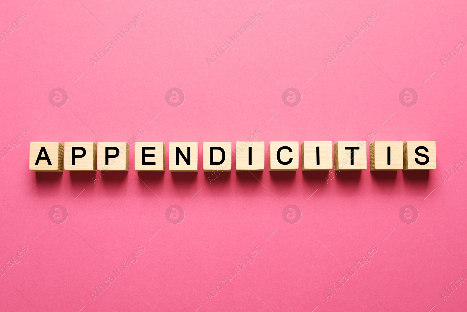 Photo of Word Appendicitis made of wooden cubes with letters on pink background, top view