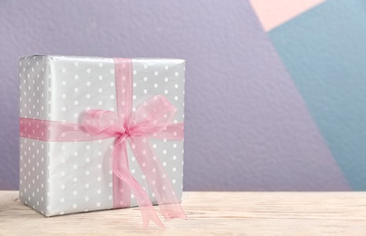Photo of Elegant gift box with bow on table