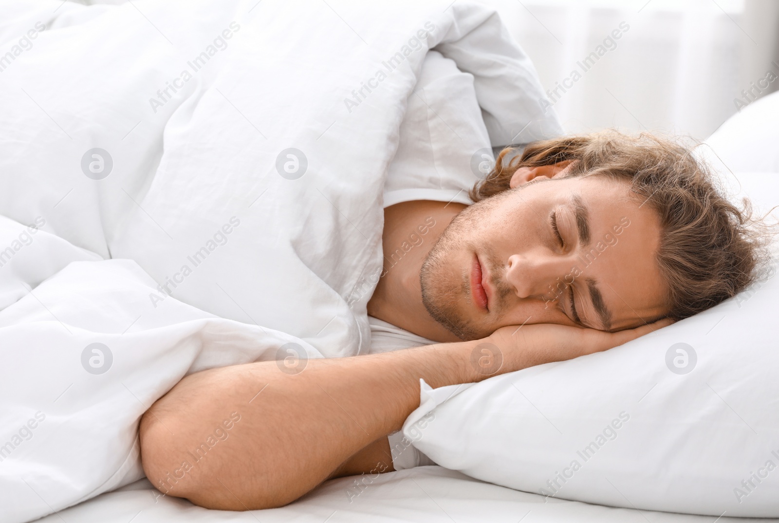 Photo of Handsome young man sleeping on pillow. Bedtime