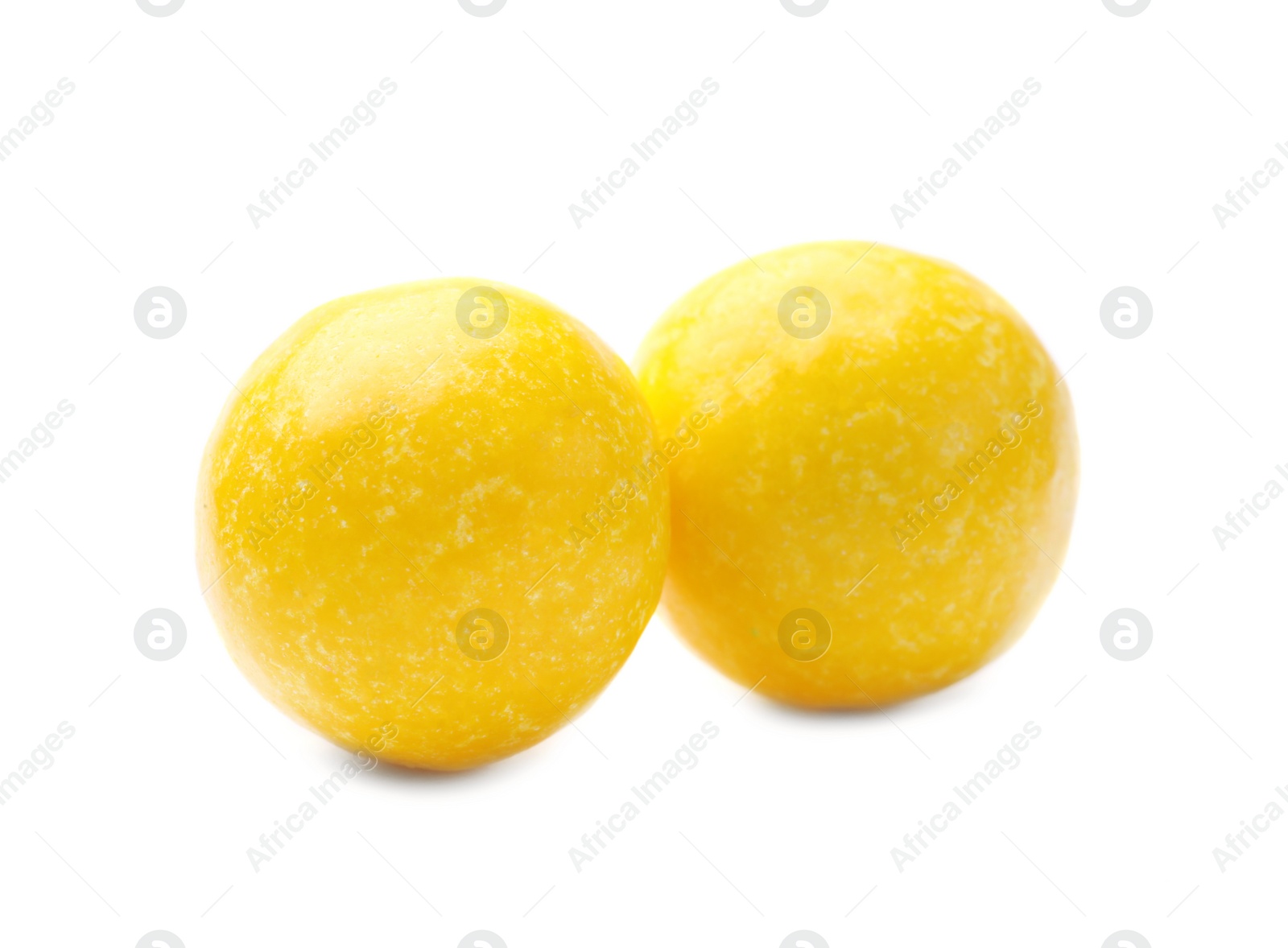 Photo of Tasty small lemon drops isolated on white