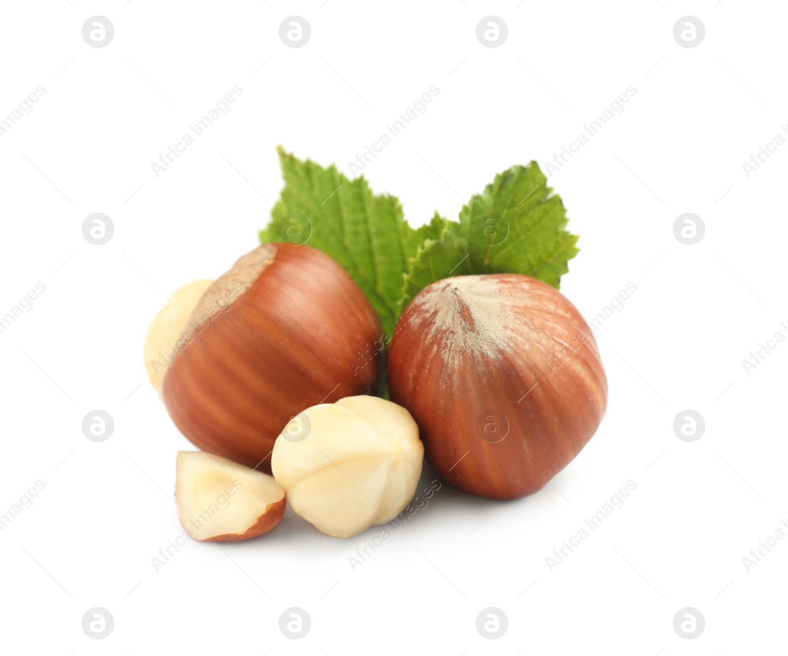 Photo of Tasty organic hazelnuts and leaves on white background