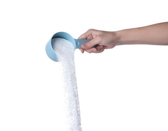 Photo of Woman pouring laundry detergent from measuring container against white background, closeup