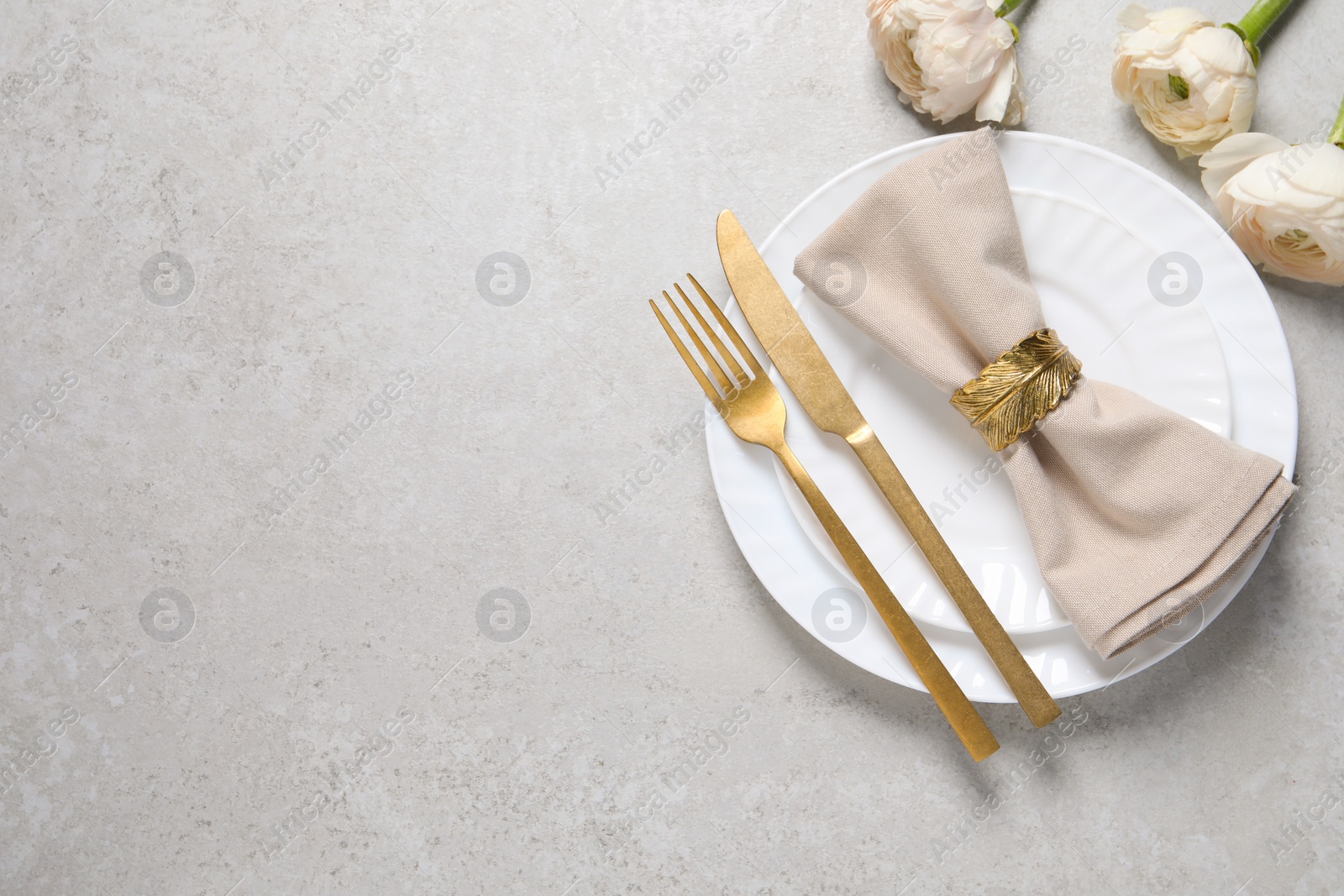 Photo of Stylish table setting with cutlery and flowers on grey background, flat lay. Space for text