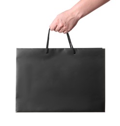 Photo of Woman holding paper shopping bag on white background, closeup