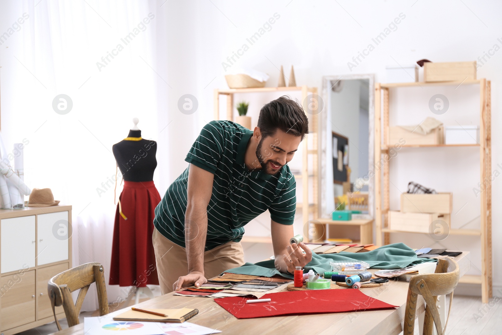 Photo of Fashion designer creating new clothes in studio