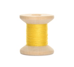 Wooden spool of yellow sewing thread isolated on white