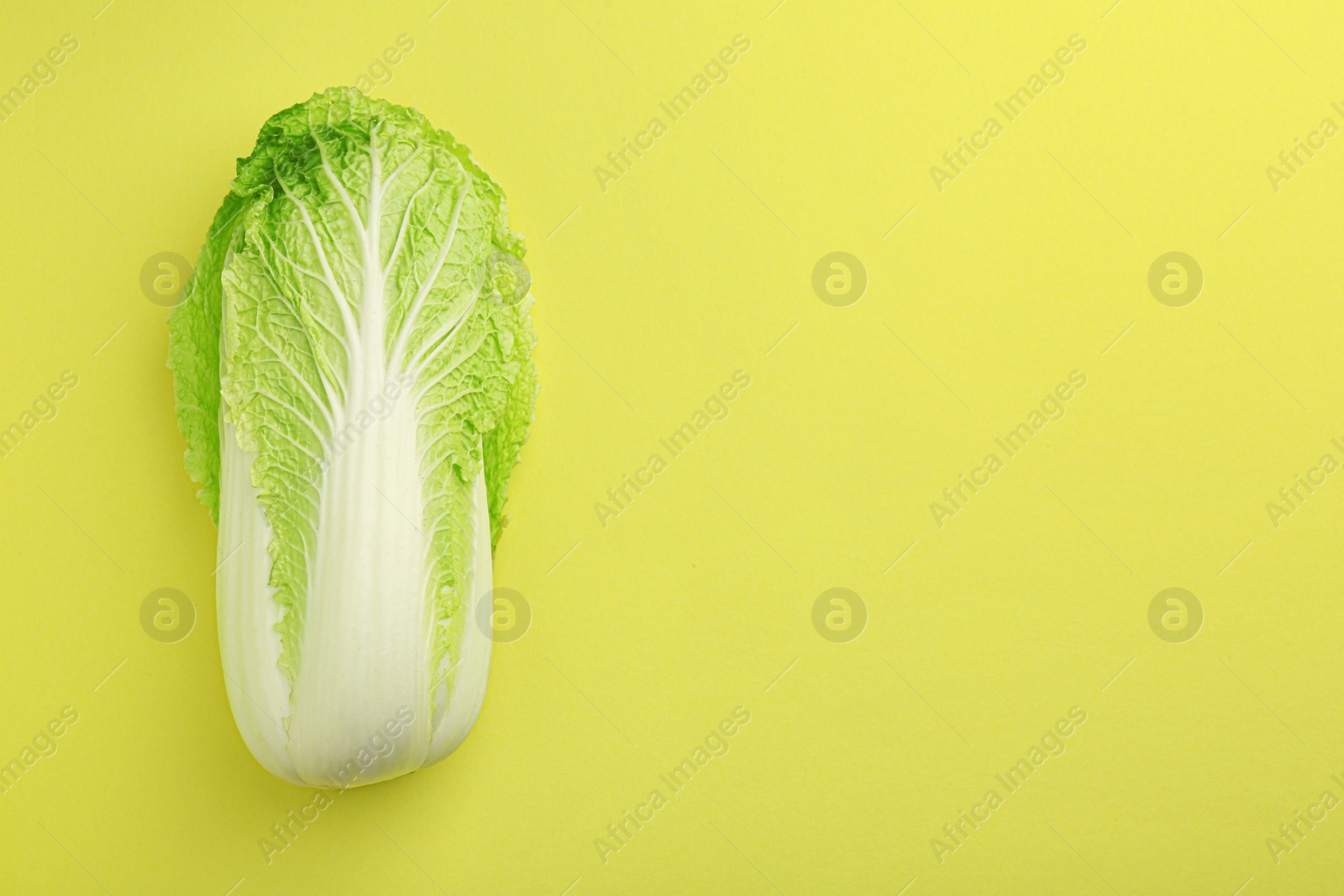 Photo of Fresh ripe Chinese cabbage on green background, top view. Space for text