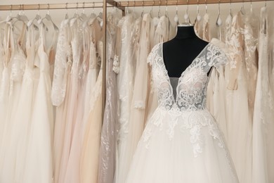 Photo of Beautiful wedding dress on mannequin in boutique