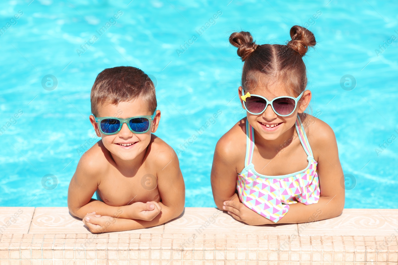 Photo of Happy cute little children in swimming pool