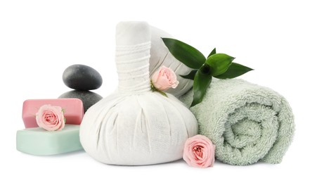 Photo of Herbal massage bags, soap, towel and spa stones on white background