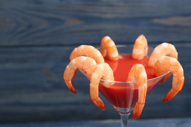 Photo of Delicious shrimp cocktail with tomato sauce, closeup