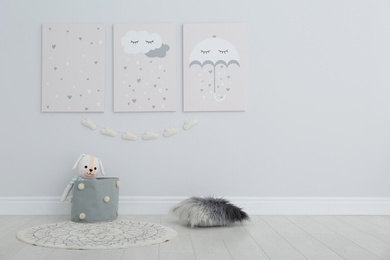 Photo of Cute posters on wall in baby room interior