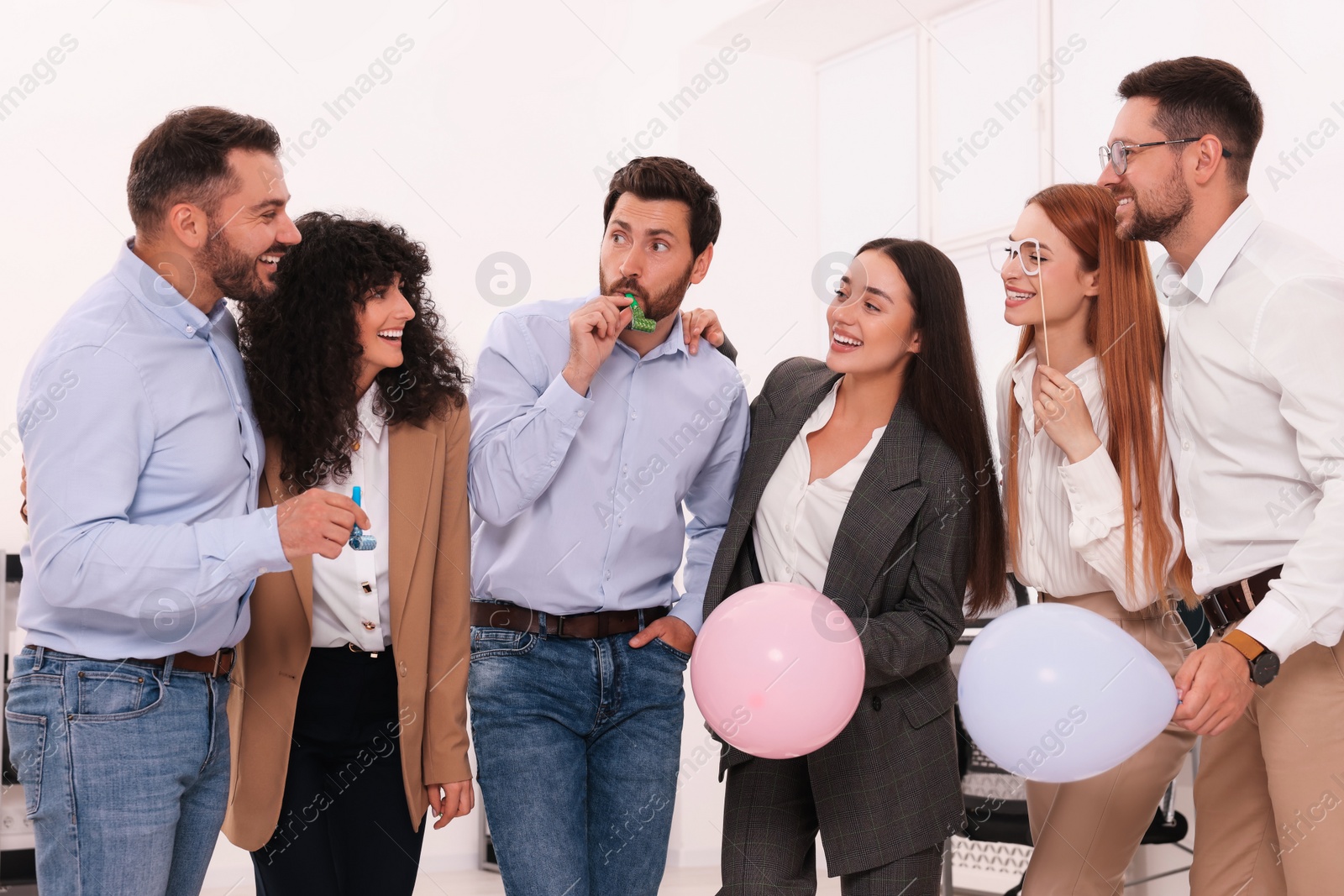 Photo of Coworkers having fun during office party indoors