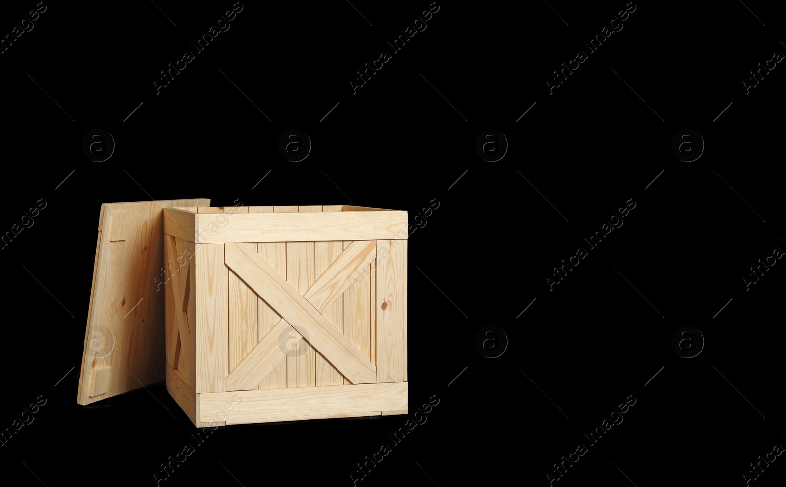 Photo of Wooden crate on black background. Space for text