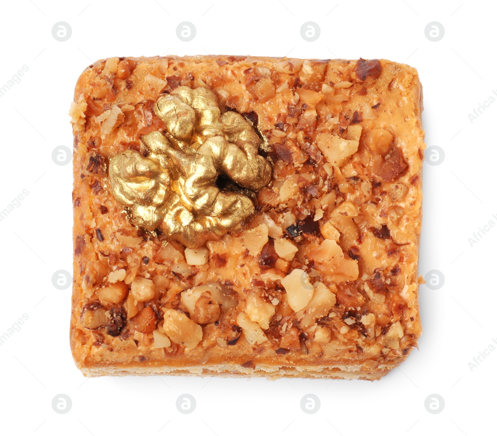 Photo of Piece of layered honey cake with walnuts on white background, top view