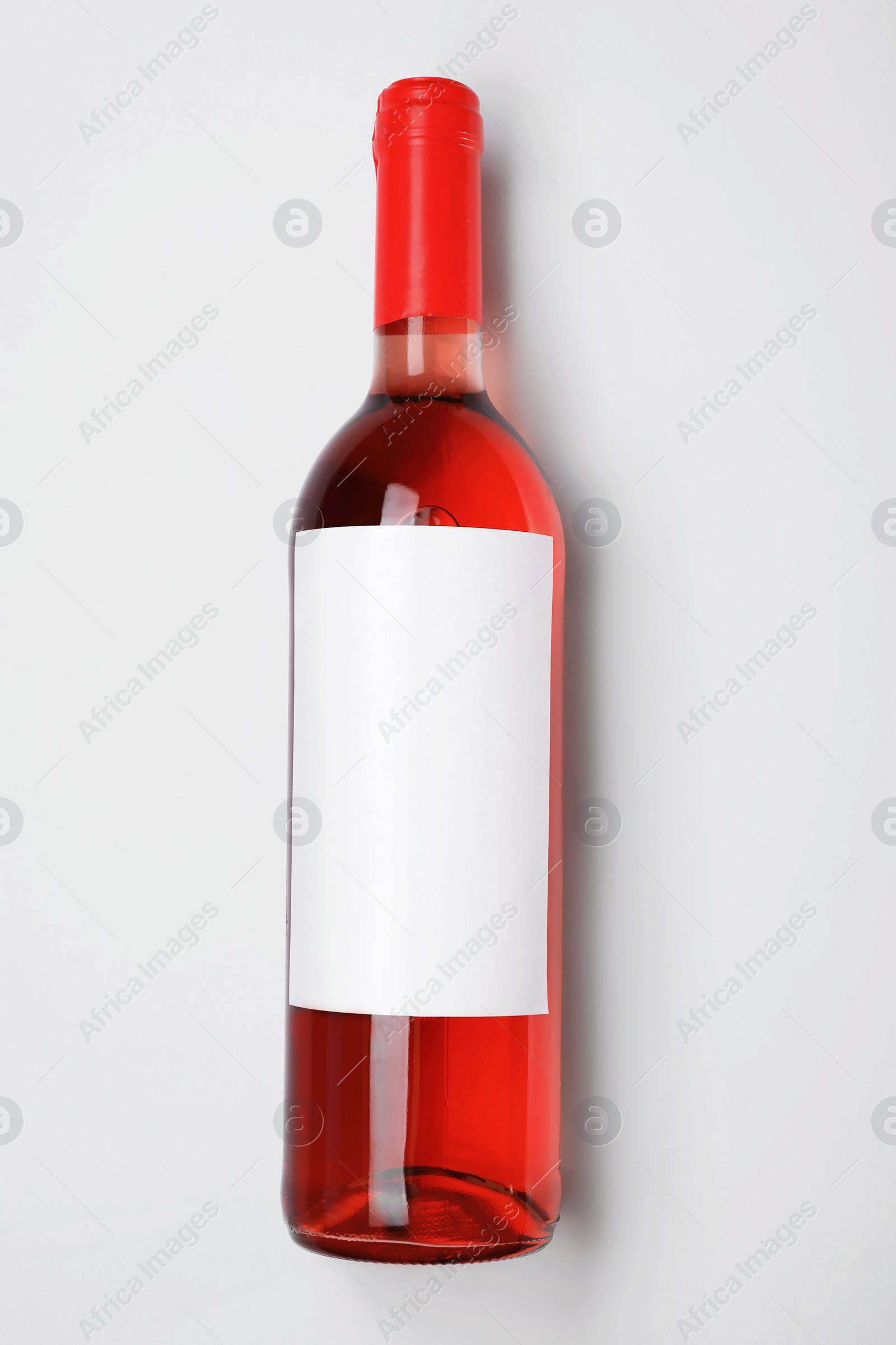 Photo of Bottle of delicious wine with blank label on white background