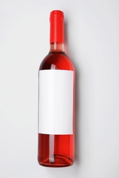 Bottle of delicious wine with blank label on white background