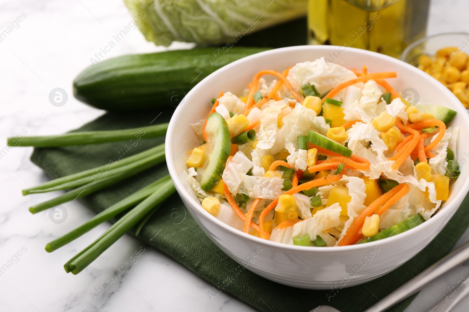 Photo of Tasty salad with Chinese cabbage served on white marble table, closeup