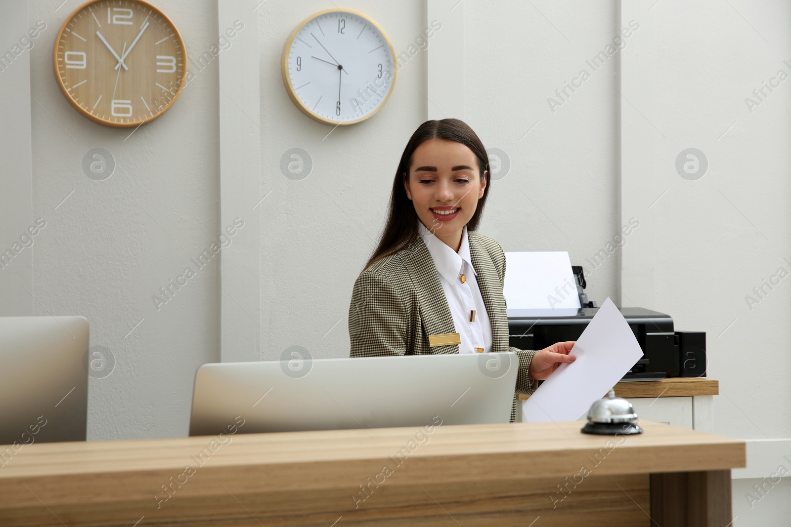 Photo of Beautiful receptionist working at counter in hotel