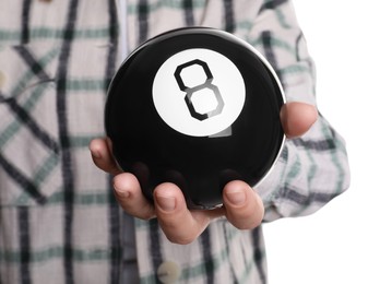 Photo of Woman holding magic eight ball on white background, closeup