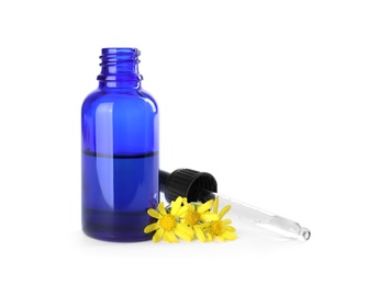 Bottle of herbal essential oil, pipette and flowers isolated on white