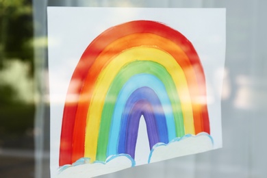 Photo of Picture of rainbow on window, view from outdoors, closeup. Stay at home concept