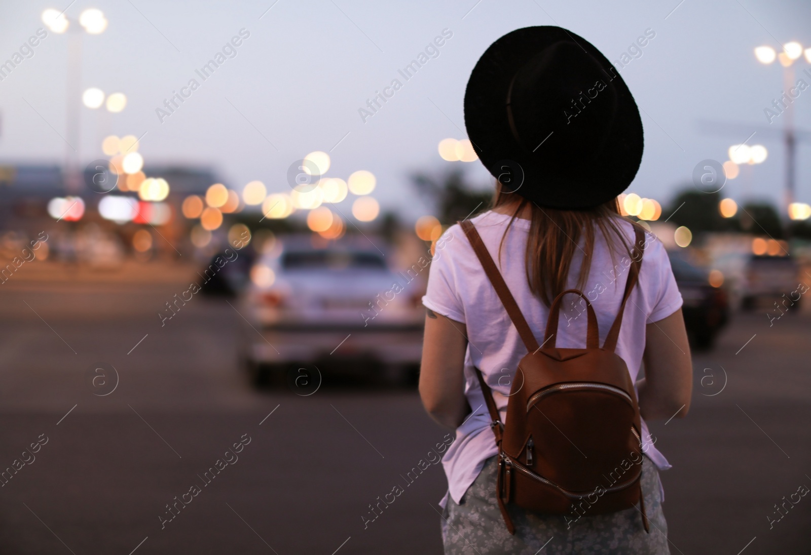 Photo of Young woman in stylish outfit on city street