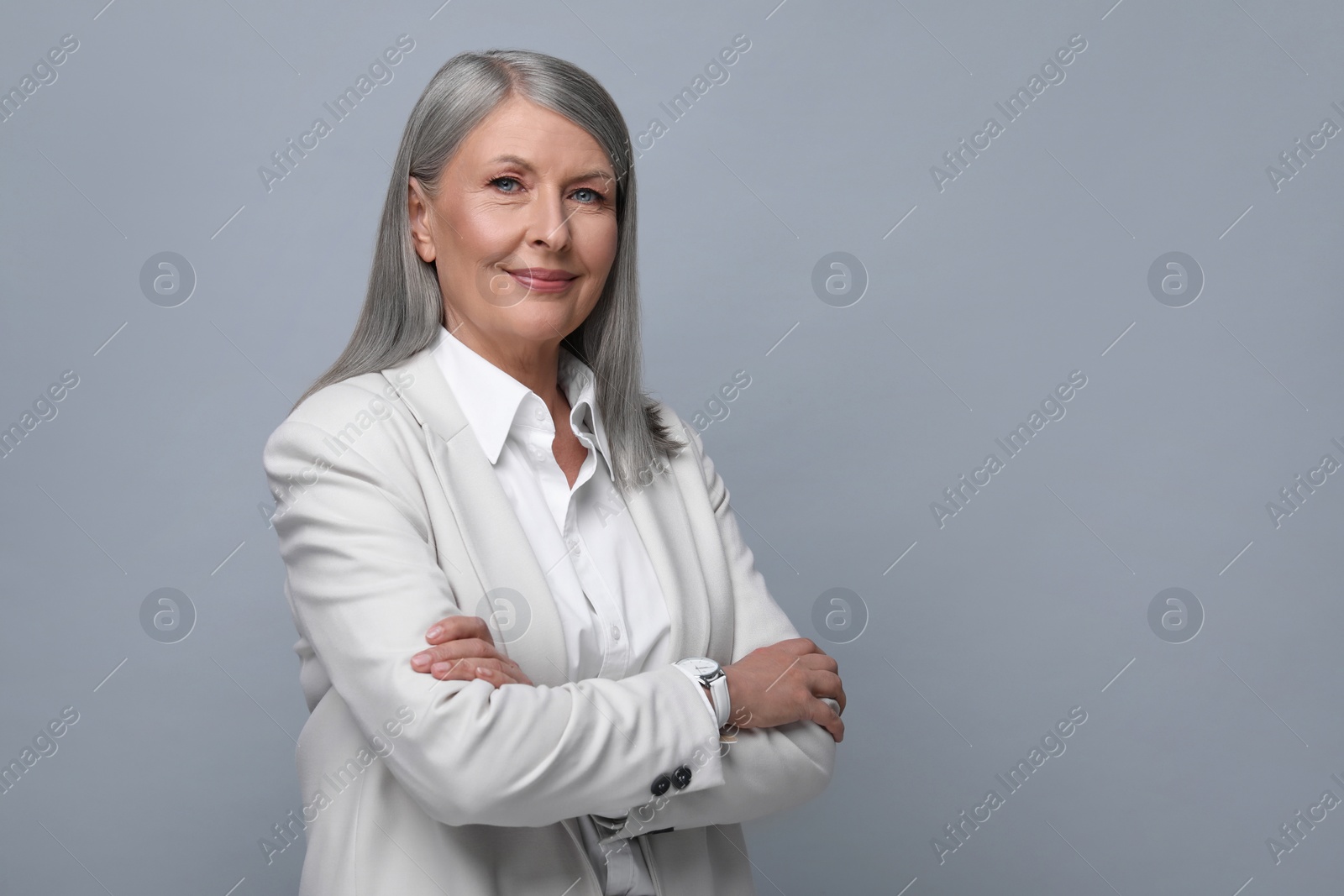 Photo of Portrait of beautiful senior woman on grey background. Space for text