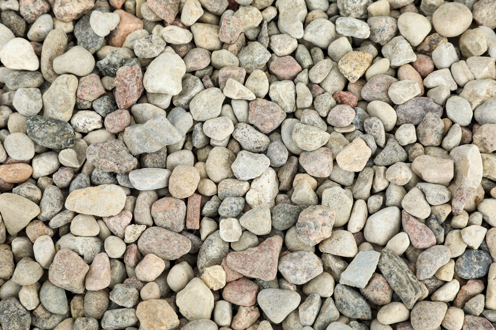 Photo of Pile of grey stones as background, top view