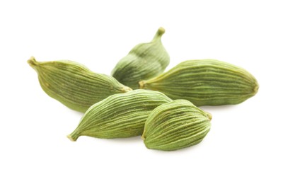 Photo of Dry green cardamom pods on white background, closeup