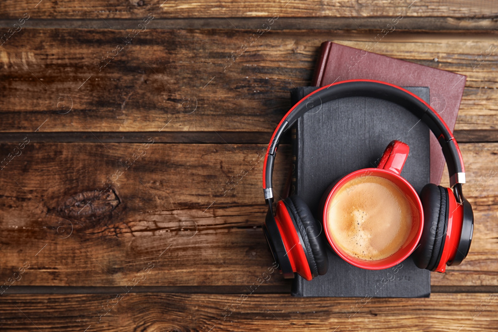 Photo of Books, coffee and headphones on wooden table, top view. Space for text