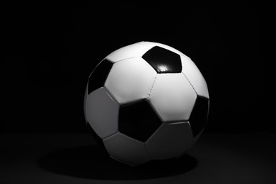 Photo of One soccer ball on black background. Sports equipment