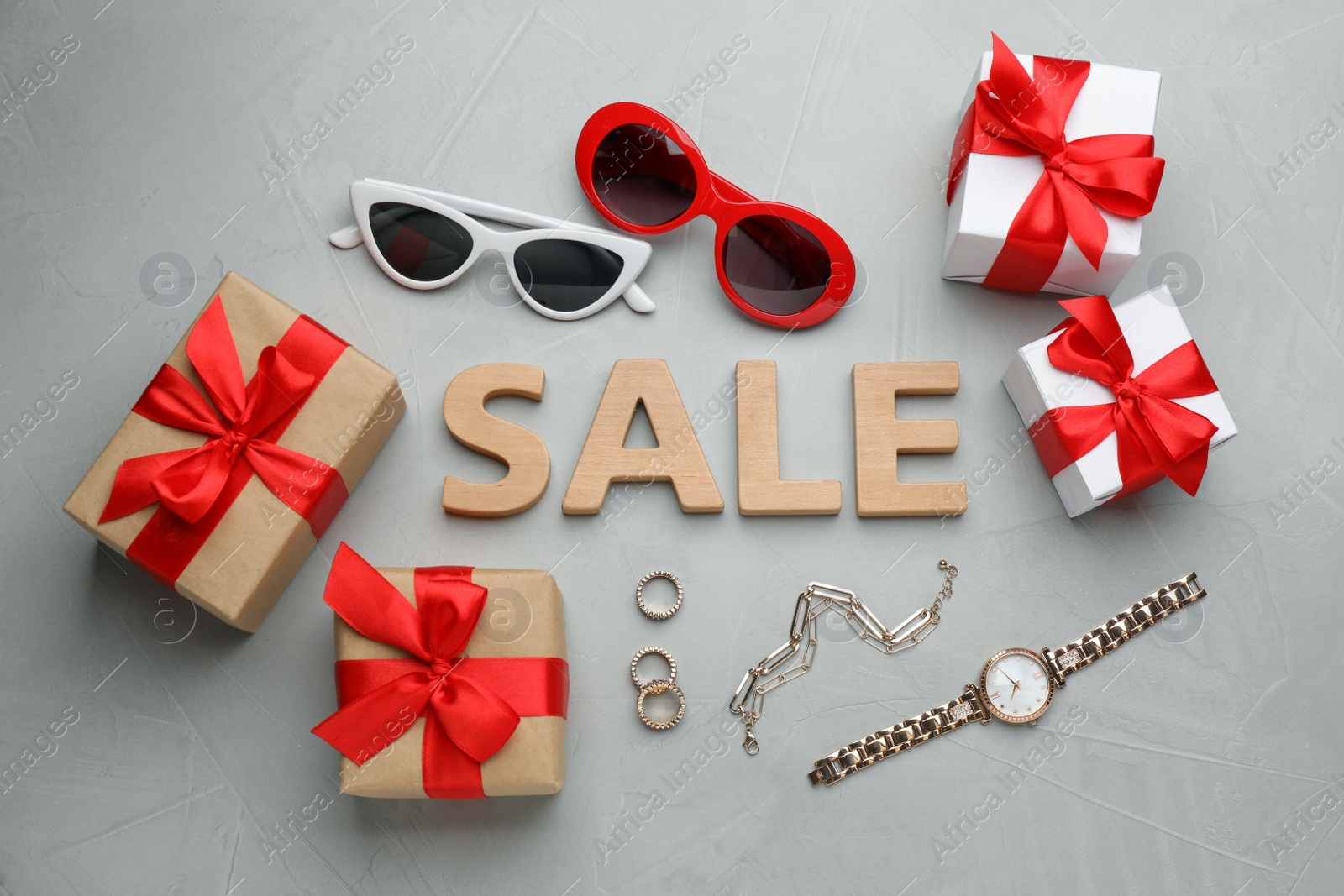 Photo of Flat lay composition with word Sale on grey background