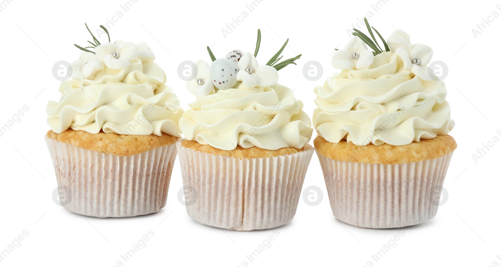 Photo of Tasty Easter cupcakes with vanilla cream isolated on white