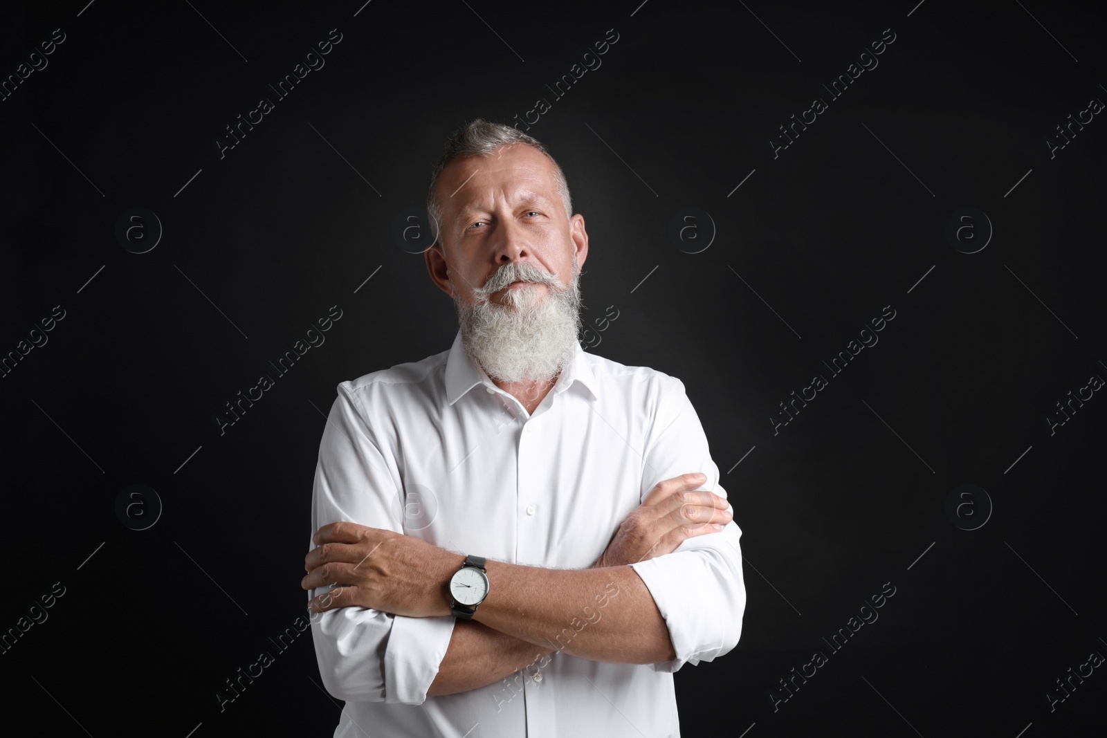 Photo of Portrait of handsome senior man on black background
