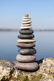 Photo of Stack of stones on rock near sea. Harmony and balance concept