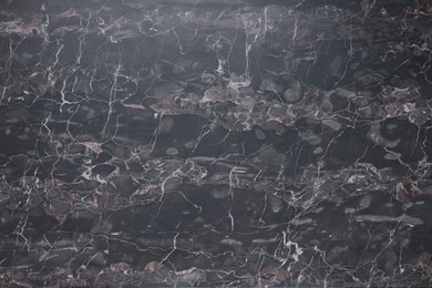 Photo of Dark grey marble surface as background, closeup