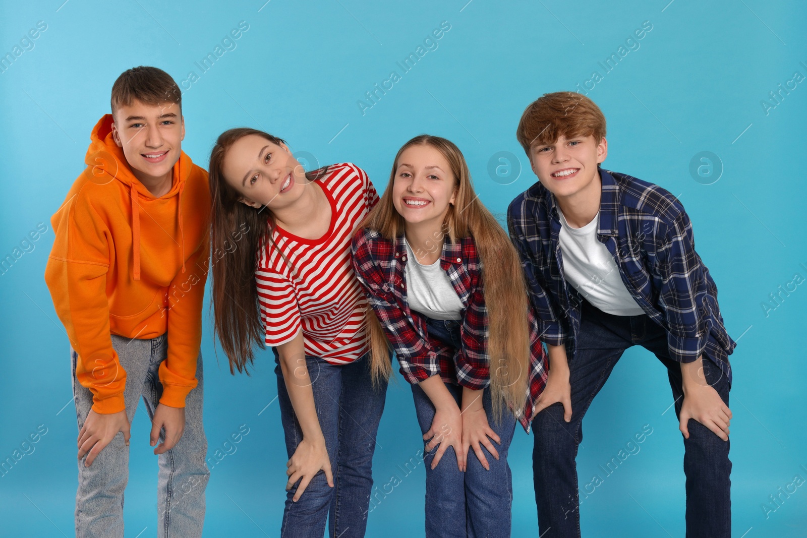 Photo of Group of teenagers on light blue background