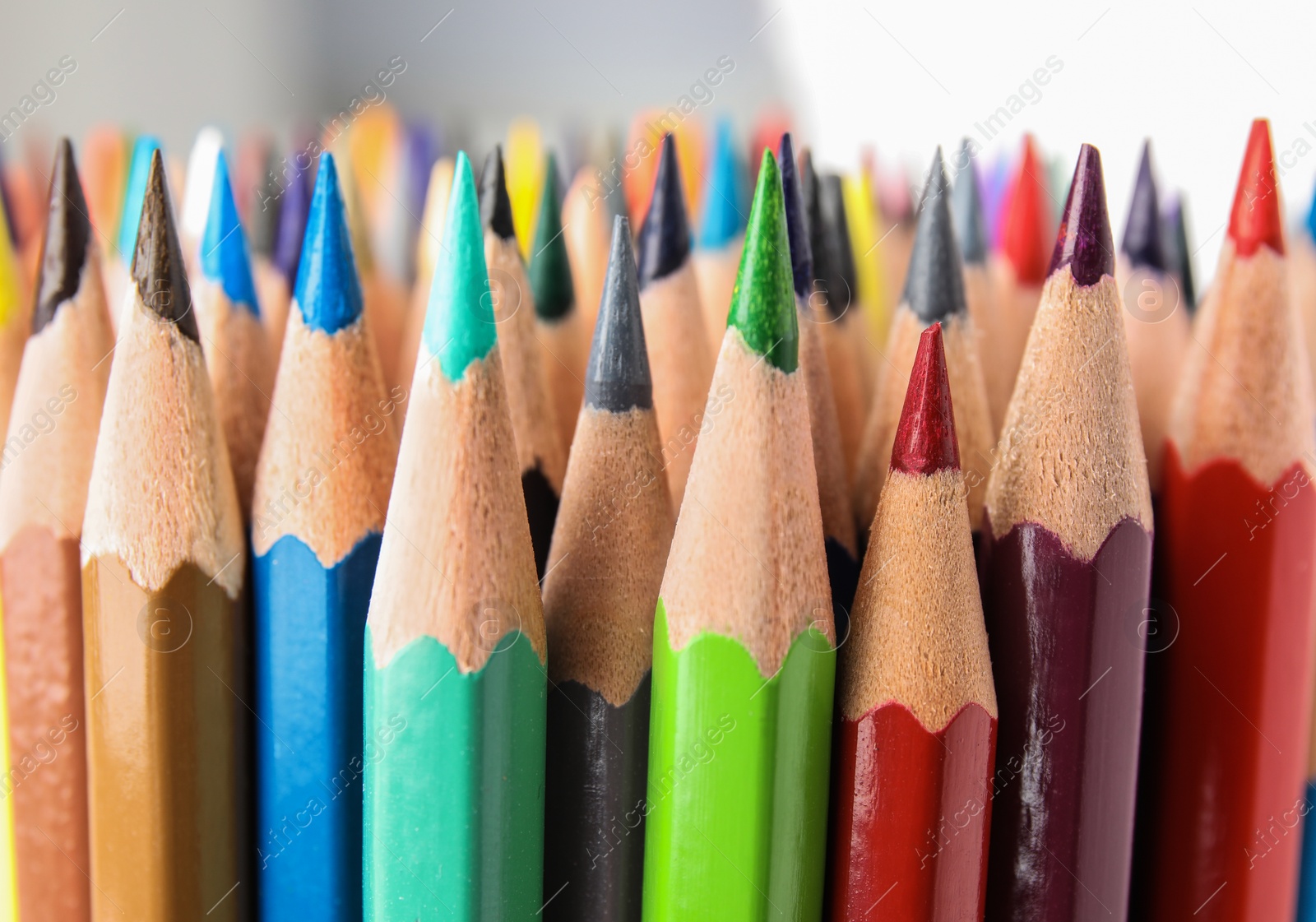 Photo of Different color pencils on white background, closeup view