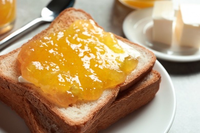 Photo of Toast bread with sweet jam on plate, closeup