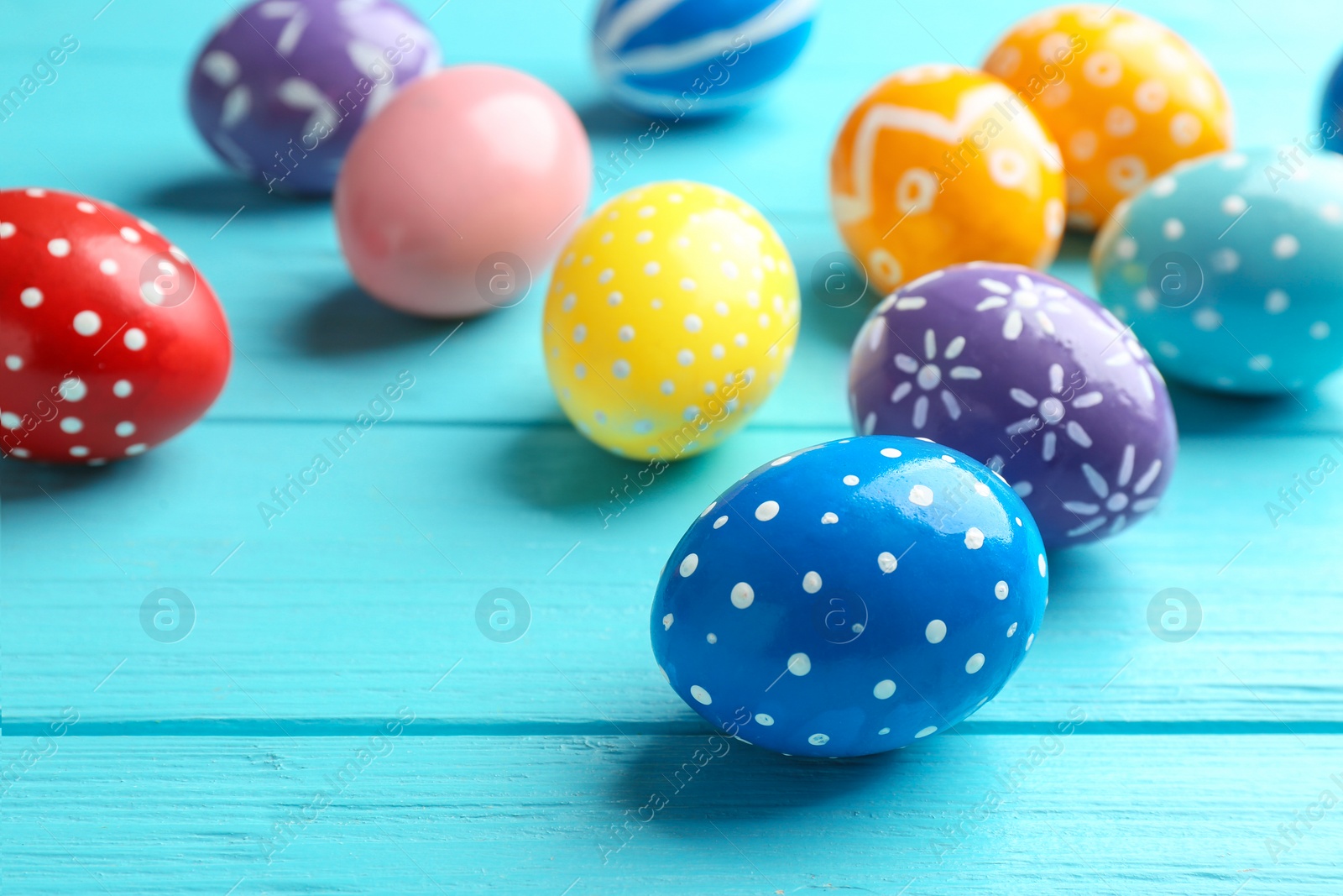 Photo of Painted Easter eggs on wooden table, space for text