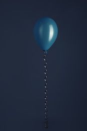 Color balloon with ribbon on dark background