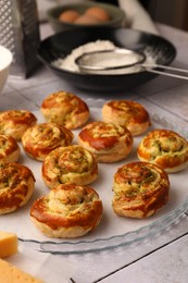 Fresh delicious puff pastry with tasty filling on white tiled surface, closeup