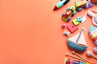 Photo of Different toys on orange background, flat lay. Space for text