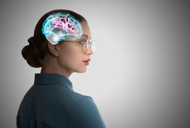 Image of Thinking concept, space for text. Young woman and illustrated brain on grey background