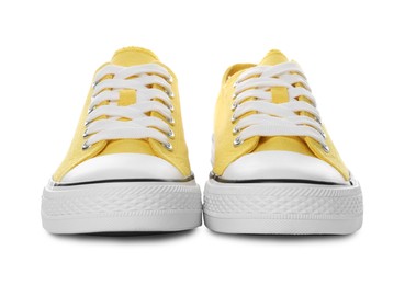 Photo of Pair of yellow classic old school sneakers on white background