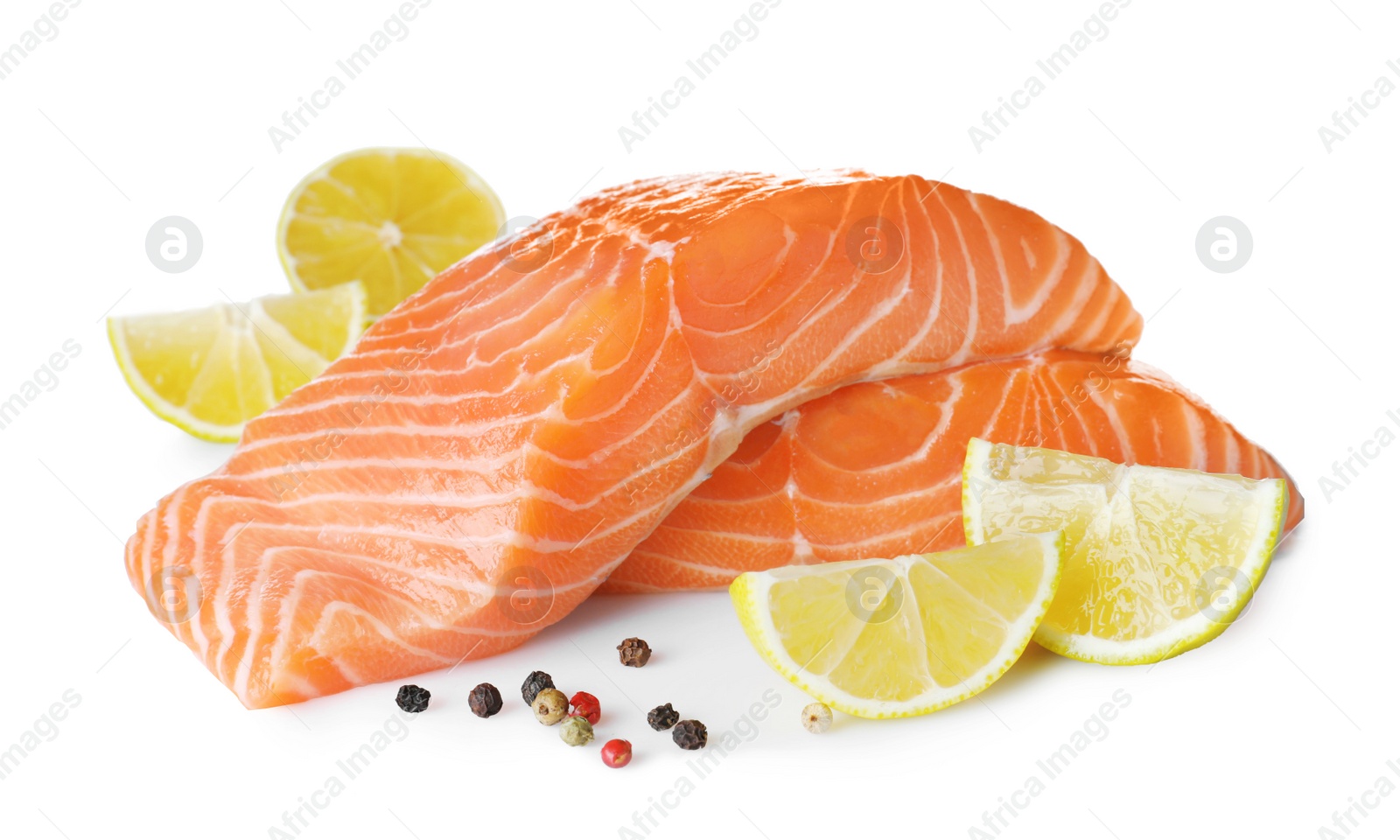 Photo of Fresh raw salmon with pepper, lime and lemon on white background. Fish delicacy