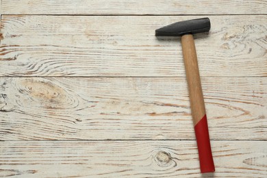 Photo of New hammer on wooden table, top view. Space for text